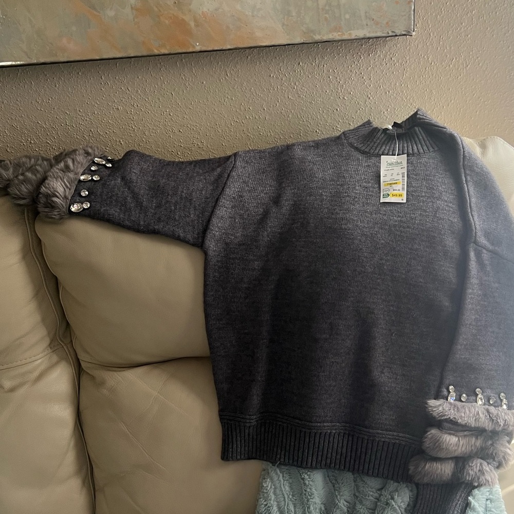 New, with tag attached sweater size medium.